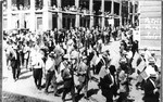 A Patriotic Parade on Main Street, circa 1917. Spectators waving American flags are on the second story of the library/post office building.