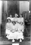 Young women in white dresses dated May 1912. Mrs. H Campbell on bottom row, far left on end. See 1976.8.2s for another picture of her.