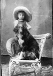 A studio portrait of a boy and his dog. Carl Vidano, age 2, taken on June 3, 1911.