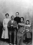 A Caretto family studio portrait taken in Torino, Italy by photographer Deastiz. Left to right: Chita, Baptiste, priest, Madalina, and Lucy Caretto. This albumen print is on a boudoir mount.