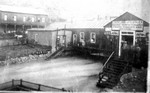 Looking southwest with Subway Street in the foreground, flooding around the first library and Lockling and Lutley store. Dated 1898.