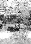 An overturned delivery wagon near some homes in Bisbee.