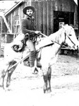 An unidentified man with a bedroll sitting on a horse in Bisbee.