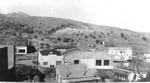 Main Street in Johnson Addition of Lowell, Arizona. The building with the arched roof was the Bledsoe Mauzy Ford Garage.