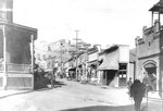 Main Street, showing the Copper Queen Library opposite of the fire station on the right. The building next to the Orient was the Fair Store, which was built in 1902 and burned down in the fire of 1908. Circa 1902-1905. The two-story brick building with Orient painted on the side is The Fair store, destroyed in 1908 and rebuilt (3 story with basement) in 1909. The white frame building left of The Fair is cobbler/saloon. The Orient Saloon is located to the right of The Fair, just below the advertisment.