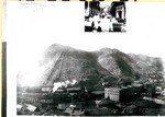 A 1903 view of Buckey O'Neill Hill, the smelter, and Bisbee. There is an inset at the top of the photo showing Main Street looking up the canyon from just below the bank. There are people and some horses and buggies in the street. Written in the upper left of the main photograph: Sunday afternoon - band concert - as seen from Y.W.C.A.