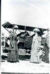 Two women and a man standing in front of a car at the inauguration of Governor Hunt. The woman on the left his Mrs. Hunt and on the right is Annie Parker Diffie. The man is unidentified.