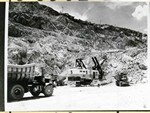 Photograph of the Lavender Pit showing 25 ton Mack Trucks and a 7 yard P&H electric shovel, circa 1950s. A man is standing by the shovel to give some idea of its size.