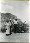 Photograph of four people taken at Montezuma's Pass in the Huachuca Mountains, circa 1930s. From left: unknown woman, unknown man, Loyce Cooper, and Eliza R. Cain. Eliza was the wife of John E. Cain.