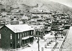 Photograph postcard showing the Copper Queen Consolidated General Office with Chihuahua Hill in the background, circa 1904. Photo captioned: Chihuahua Hill. Photo by Humphries Photo Company and published in El Paso, Texas.