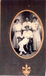 A studio portrait of John Maffeo (seated) and Ella Holohan Maffeo (left) with unidentified friends in Globe, Arizona. The individuals are dressed for a theatrical production, in which they participated.