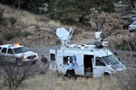 The KVOA Channel 4 Tucson News van, parked alongside Highway 80, covering the Thirty Moon Fire on March 20, 2008. A Cochise County Sheriff's SUV is parked behind the news van.