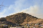 View of the Thirty Moon Fire above High Road, March 20, 2008. Houses and the top of the old Bisbee High School are in the foreground.