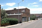 The old Brophy building on Erie Street in Lowell. The traffic circle is visible in the background. Wittig Once Upon a Mine collection.