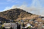 View of the Thirty Moon Fire above High and Temby roads, March 20, 2008. Note the smoke and the proximity of the fire to the homes. Old Bisbee High School in the bottom left corner.